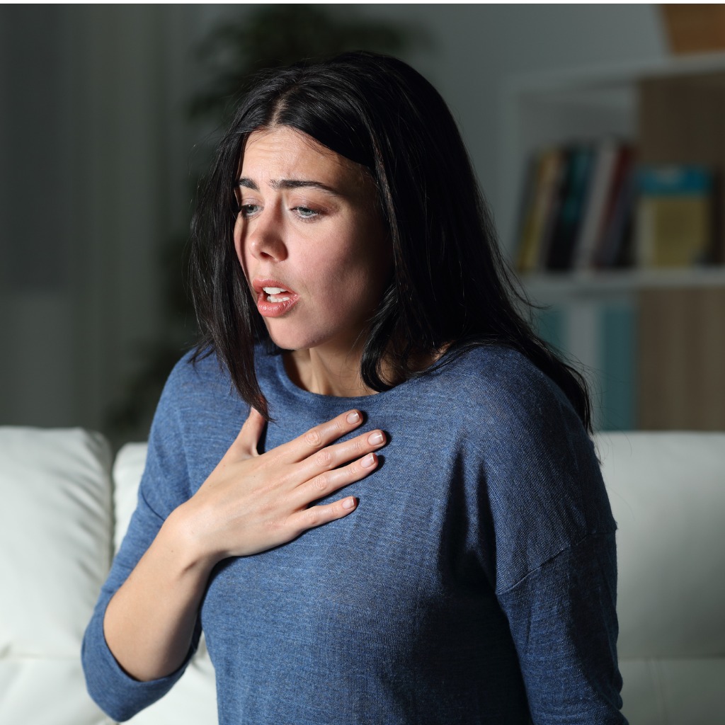 Woman suffering an anxiety attack alone in the night.